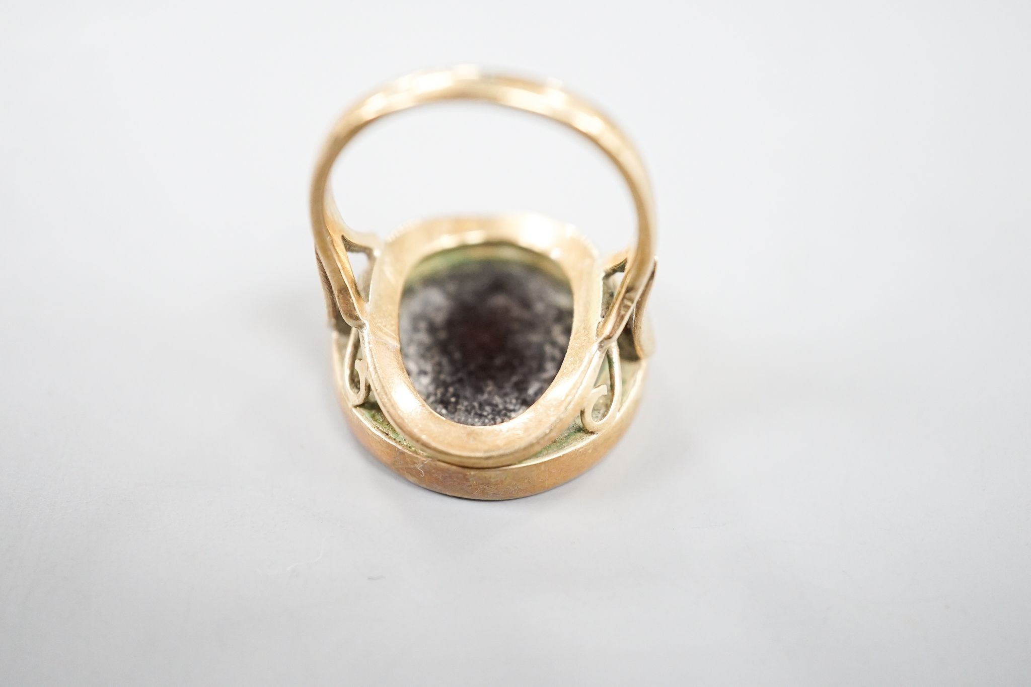 An early 20th century 9ct and intaglio brown chalcedony set ring, carved with the bust of a lady to dexter, size Q, gross weight 8.4 grams.